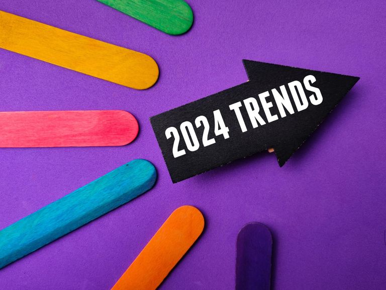 a blue background with multi colored popsicles all pointing towards an arrow saygin 2024 trends.