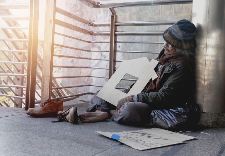 A homeless person sleeping in a stairwell