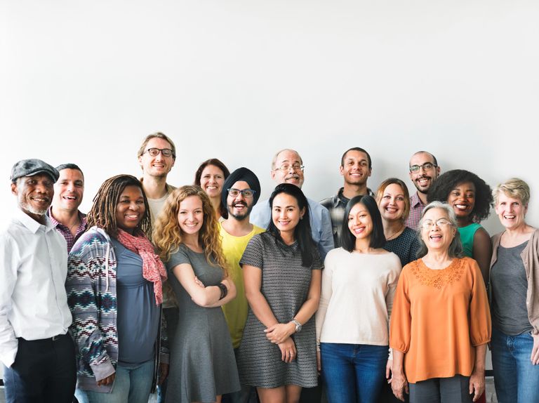 a multi culteral diverse group of people smiling 