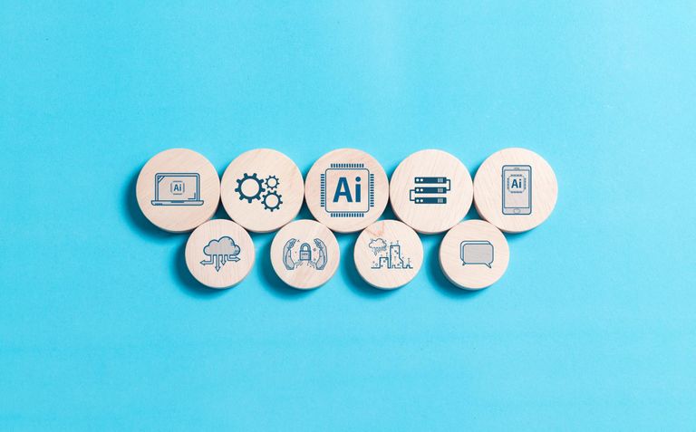 9 wood circles on two lines. Top line: 5 circles of medium sizes; bottom line: 5 circles of smaller sizes. 
Each wood circle has a blue icon, such as user interface, mobile interface, gears, AI, Privacy, Cloud, etc.
Background is ocean blue.